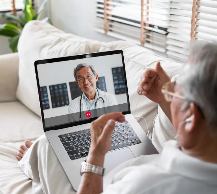 Senior man doing a telehealth video call with a doctor on his laptop through Independa